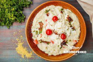 Kulish (savory millet porridge) with sour pickled tomato and mozzarella